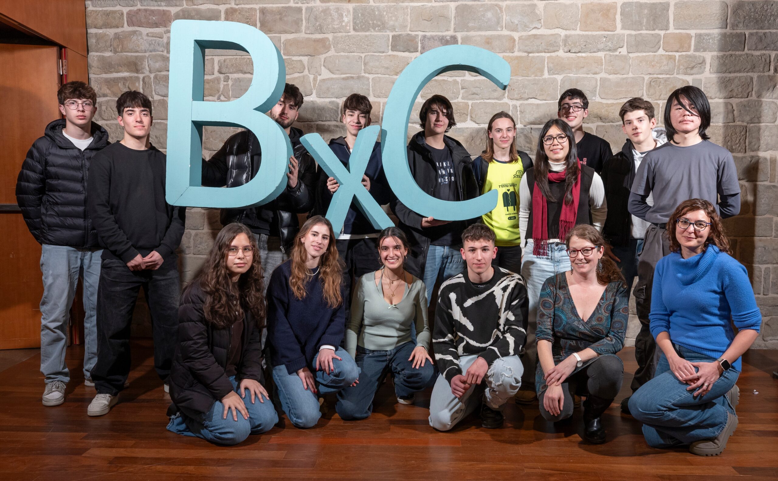Students holding BXC letters during an Escolab visit at IREC, a Barcelona City Council initiative that connects secondary and vocational students with active scientific research laboratories and energy innovation.
