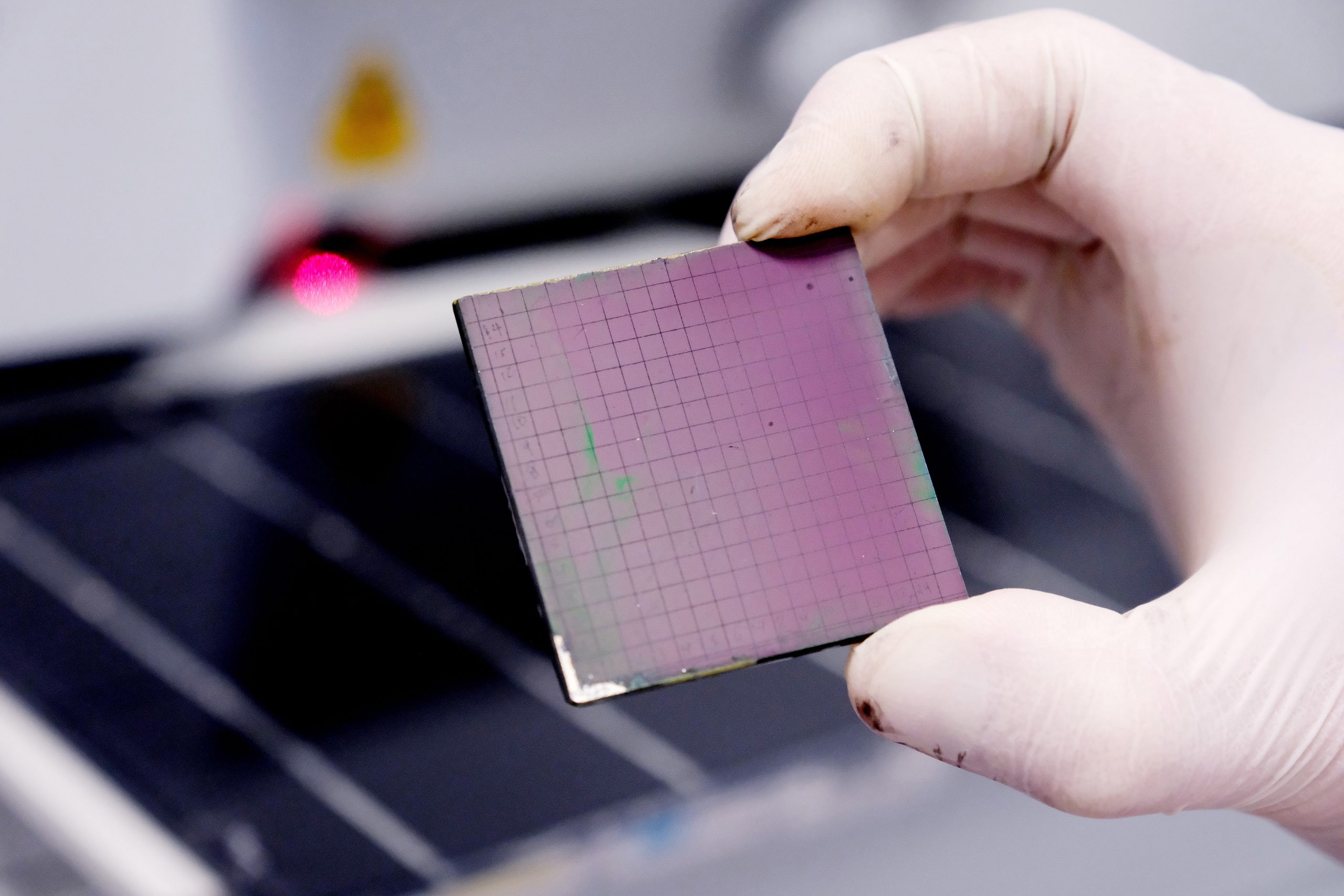 Microchip with grid pattern, representing semiconductor technology and advanced computational systems used in materials characterization and energy device analysis.