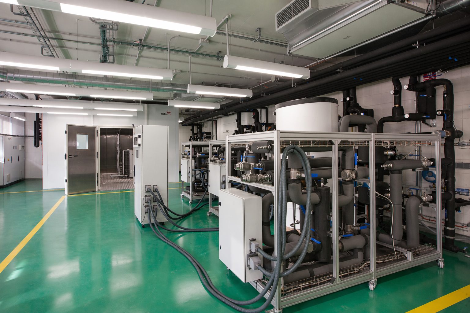 Large laboratory room with multiple machines and experimental systems for energy research, supporting decarbonisation modelling, smart grid analysis and sustainable technology development.