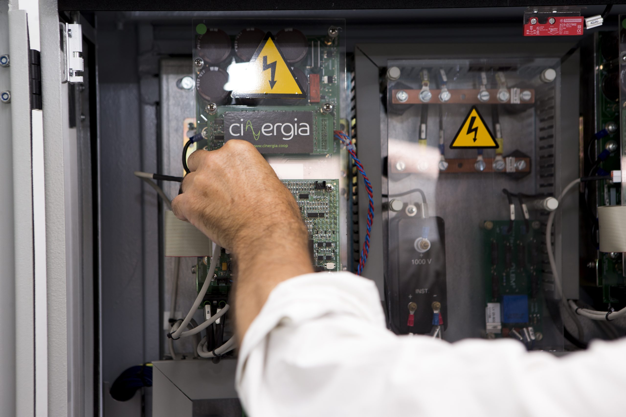 Scientist adjusting HVAC control system equipment in a laboratory for advanced building energy management, model predictive control and renewable-integrated smart grid operation.